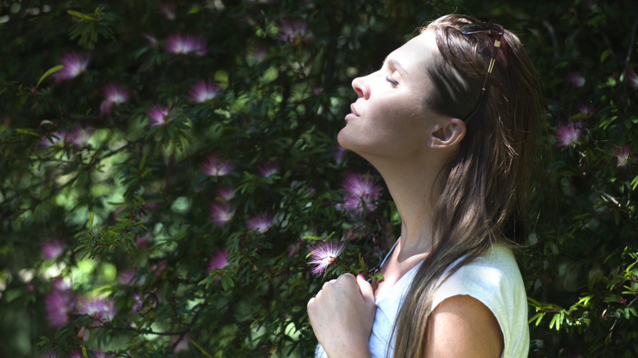 A woman pausing to breathe in nature